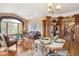 Spacious living room featuring hardwood floors, fireplace, built-in bookshelves and large picture windows at 19595 E Top O The Moor Dr, Monument, CO 80132