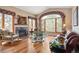 Cozy living room with a fireplace, hardwood floors, and large windows at 19595 E Top O The Moor Dr, Monument, CO 80132