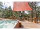 Scenic back deck offers a hot tub, dining area, and shade to enjoy beautiful outdoor views at 27407 Upper Cold Spg Gulch Rd, Golden, CO 80401