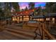Inviting back deck with a hot tub and stylish sunshade, perfect for outdoor relaxation at 27407 Upper Cold Spg Gulch Rd, Golden, CO 80401