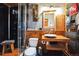 Stylish bathroom boasts modern fixtures, a wood vanity, and a standing glass enclosed shower at 27407 Upper Cold Spg Gulch Rd, Golden, CO 80401