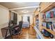 Cozy bedroom/office featuring a built in desk, bookcase, and hardwood floors at 27407 Upper Cold Spg Gulch Rd, Golden, CO 80401