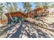 Beautiful home exterior featuring a two-car garage and hillside landscaping at 27407 Upper Cold Spg Gulch Rd, Golden, CO 80401