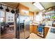 Functional kitchen with wood cabinets, stainless steel refrigerator, and modern appliances at 27407 Upper Cold Spg Gulch Rd, Golden, CO 80401