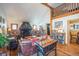 Comfortable living room featuring a stone fireplace, hardwood floors, and ample seating at 27407 Upper Cold Spg Gulch Rd, Golden, CO 80401