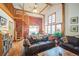 Cozy living room with spiral staircase, exposed beams, and rustic decor at 27407 Upper Cold Spg Gulch Rd, Golden, CO 80401
