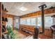 Cozy living room boasts wood flooring, a pellet stove, a bench seat, and an abundance of natural light at 27407 Upper Cold Spg Gulch Rd, Golden, CO 80401