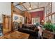 Cozy living room with spiral staircase, exposed beams, and rustic decor at 27407 Upper Cold Spg Gulch Rd, Golden, CO 80401