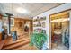 Cozy living room featuring wood flooring, a pellet stove, display shelving, and access to the bathroom at 27407 Upper Cold Spg Gulch Rd, Golden, CO 80401
