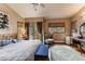 Spacious main bedroom features a vaulted ceiling, a ceiling fan, access to a balcony, and a vanity at 27407 Upper Cold Spg Gulch Rd, Golden, CO 80401