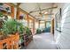 Bright sun room filled with plants featuring wood trim, lots of windows, and ceiling fan at 27407 Upper Cold Spg Gulch Rd, Golden, CO 80401