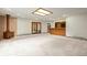 Open basement area featuring a wet bar, wood-burning stove, and access to the backyard at 7351 Poppy Way, Arvada, CO 80007