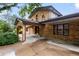 Brick home featuring a covered driveway and grand entrance with arched brick entryway at 7351 Poppy Way, Arvada, CO 80007