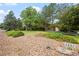 Landscaped front yard and grass with a visible street number sign at 7351 Poppy Way, Arvada, CO 80007