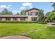 Charming brick home with lush front yard, mature trees, and manicured hedges enhances curb appeal at 7351 Poppy Way, Arvada, CO 80007