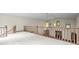 Open hallway with wood railing overlooking the lower level with natural light, and arched windows at 7351 Poppy Way, Arvada, CO 80007