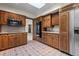Charming kitchen featuring wooden cabinets, tile flooring, built-in appliances and ample storage at 7351 Poppy Way, Arvada, CO 80007
