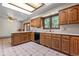 Well-lit kitchen with wood cabinets, laminate countertops, and a view of the outdoors at 7351 Poppy Way, Arvada, CO 80007