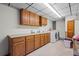 Well-equipped laundry room with washer, dryer, sink, and counter space for convenience at 7351 Poppy Way, Arvada, CO 80007