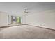 A carpeted living room, including a large window at 7351 Poppy Way, Arvada, CO 80007