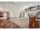 Expansive living area featuring a second-story balcony, wood trim, and fireplace in the adjacent room at 7351 Poppy Way, Arvada, CO 80007