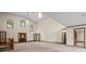 Open living space with tall windows, front door, and connecting doors for easy access at 7351 Poppy Way, Arvada, CO 80007