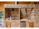 Brick outdoor kitchen and BBQ featuring a sink and mini-fridge for convenient entertaining at 7351 Poppy Way, Arvada, CO 80007