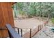 Backyard with wood fence on a hillside overlooking wooded area at 5976 Stone Creek Dr, Evergreen, CO 80439