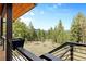 Backyard view showcasing a large, well-maintained yard and distant mountain range at 5976 Stone Creek Dr, Evergreen, CO 80439