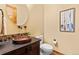 Bathroom features earth tones, decorative copper sink, and modern fixtures at 5976 Stone Creek Dr, Evergreen, CO 80439