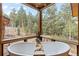 A view of a bathroom with two tubs and an amazing forest view at 5976 Stone Creek Dr, Evergreen, CO 80439