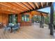 Outdoor patio features wood ceiling, bar seating, and dining area with scenic views at 5976 Stone Creek Dr, Evergreen, CO 80439