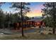 Stunning modern home featuring a three-car garage and a lush, wooded landscape with mountain views at 5976 Stone Creek Dr, Evergreen, CO 80439