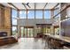 Sunlit great room boasts soaring ceilings, a stone fireplace, and an open layout perfect for entertaining at 5976 Stone Creek Dr, Evergreen, CO 80439