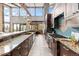 Gourmet kitchen featuring custom cabinetry, granite countertops, and high-end stainless steel appliances at 5976 Stone Creek Dr, Evergreen, CO 80439