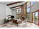 Elegant living room featuring high ceilings, stone fireplace, and ample natural light at 5976 Stone Creek Dr, Evergreen, CO 80439