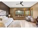Well-lit main bedroom with large windows, comfortable bed, accent chair, and stylish furnishings at 5976 Stone Creek Dr, Evergreen, CO 80439