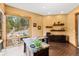 Sunlit office with desk and shelving, offering views of the landscaped yard at 5976 Stone Creek Dr, Evergreen, CO 80439