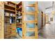 Walk-in pantry features custom shelving and storage, with frosted-glass door at 5976 Stone Creek Dr, Evergreen, CO 80439