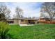 Spacious backyard featuring a covered patio area perfect for outdoor entertaining and a well-maintained lawn at 6020 Quail St, Arvada, CO 80004