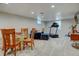 Finished basement features carpet, seating, and a treadmill at 6020 Quail St, Arvada, CO 80004