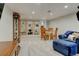 Finished basement features carpet, recessed lighting, and ample seating at 6020 Quail St, Arvada, CO 80004