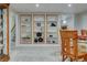 A finished basement features custom built-in shelving for storage and decor, with soft carpet flooring at 6020 Quail St, Arvada, CO 80004