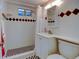 Bathroom featuring tiled shower, classic vanity, black and white tiled flooring, and decorative diamond accents at 6020 Quail St, Arvada, CO 80004