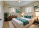 Bedroom features wood floors, two windows, and a queen size bed at 6020 Quail St, Arvada, CO 80004