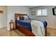 Bedroom features wood floors, a window, and a full size bed at 6020 Quail St, Arvada, CO 80004