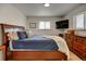 Bedroom features wood floors, two windows, and a full size bed at 6020 Quail St, Arvada, CO 80004
