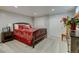 A comfortable bedroom showcases a plush bed, closet, and colorful floral arrangement for a relaxing retreat at 6020 Quail St, Arvada, CO 80004