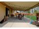View of the covered patio with stylish outdoor furniture and charming string lights for evening ambiance at 6020 Quail St, Arvada, CO 80004
