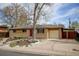 Single-story brick home featuring well-maintained landscaping, a charming front entrance, and a driveway at 6020 Quail St, Arvada, CO 80004